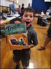 An excited youngster with his win in the children's silent auction raffle